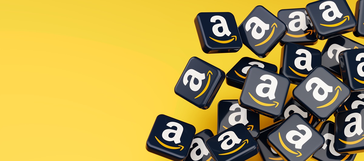 High-resolution 3D render of scattered Amazon logo tiles on a bold yellow background. Concept image for ecommerce, online shopping, logistics, retail technology and marketplace platforms.